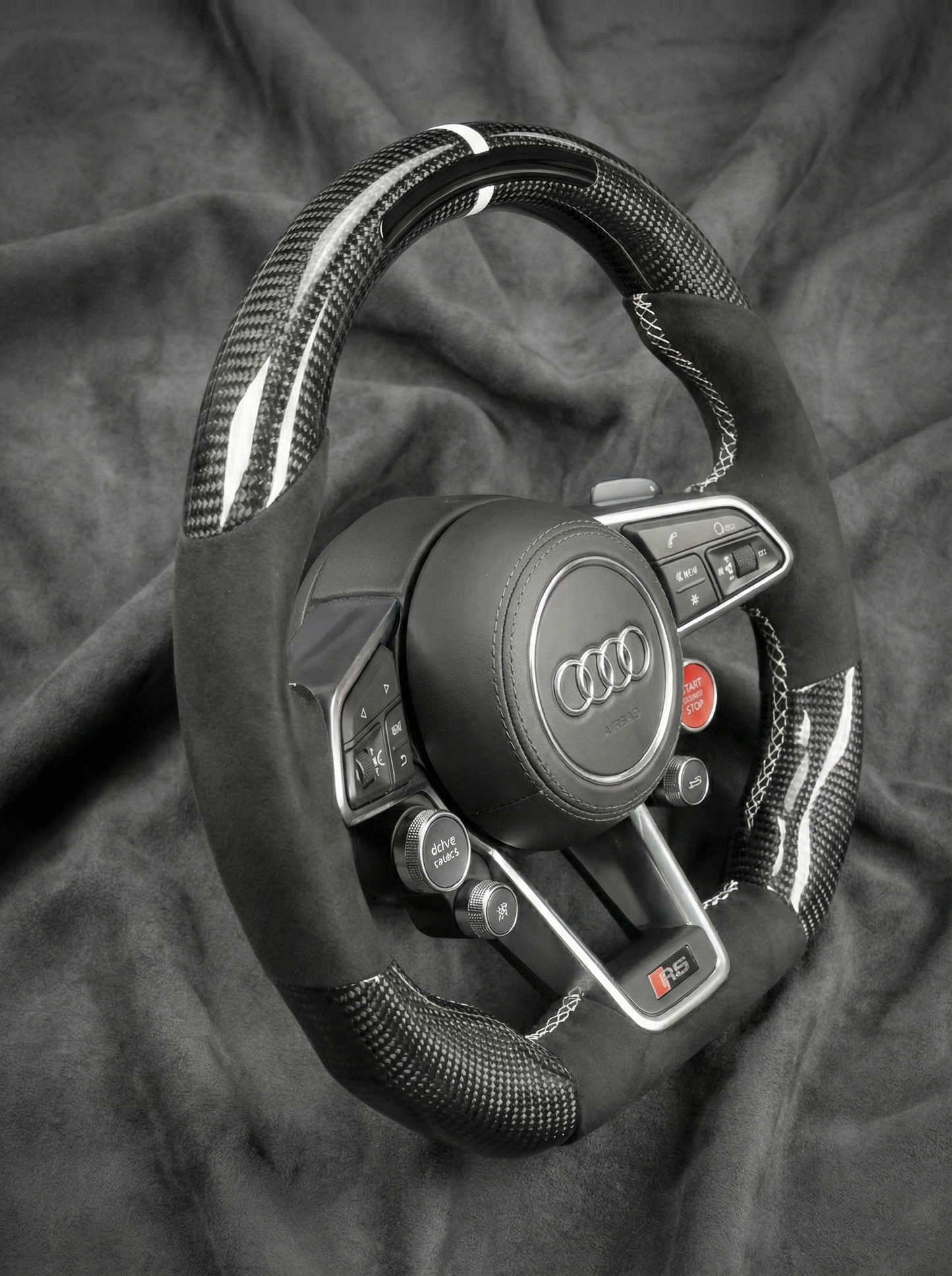 Audi steering wheel on a dark fabric background