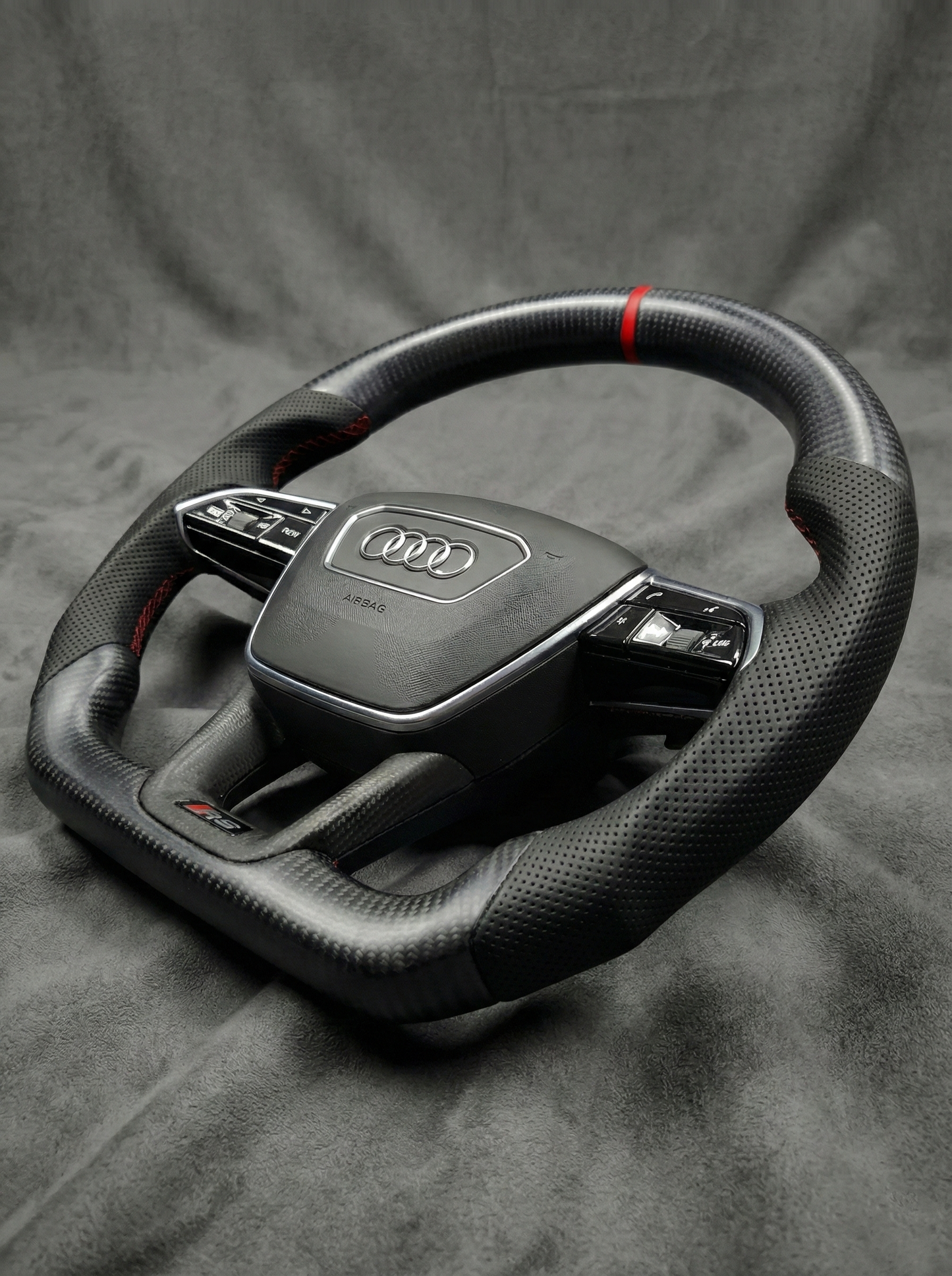 Car steering wheel with Audi logo on a gray background