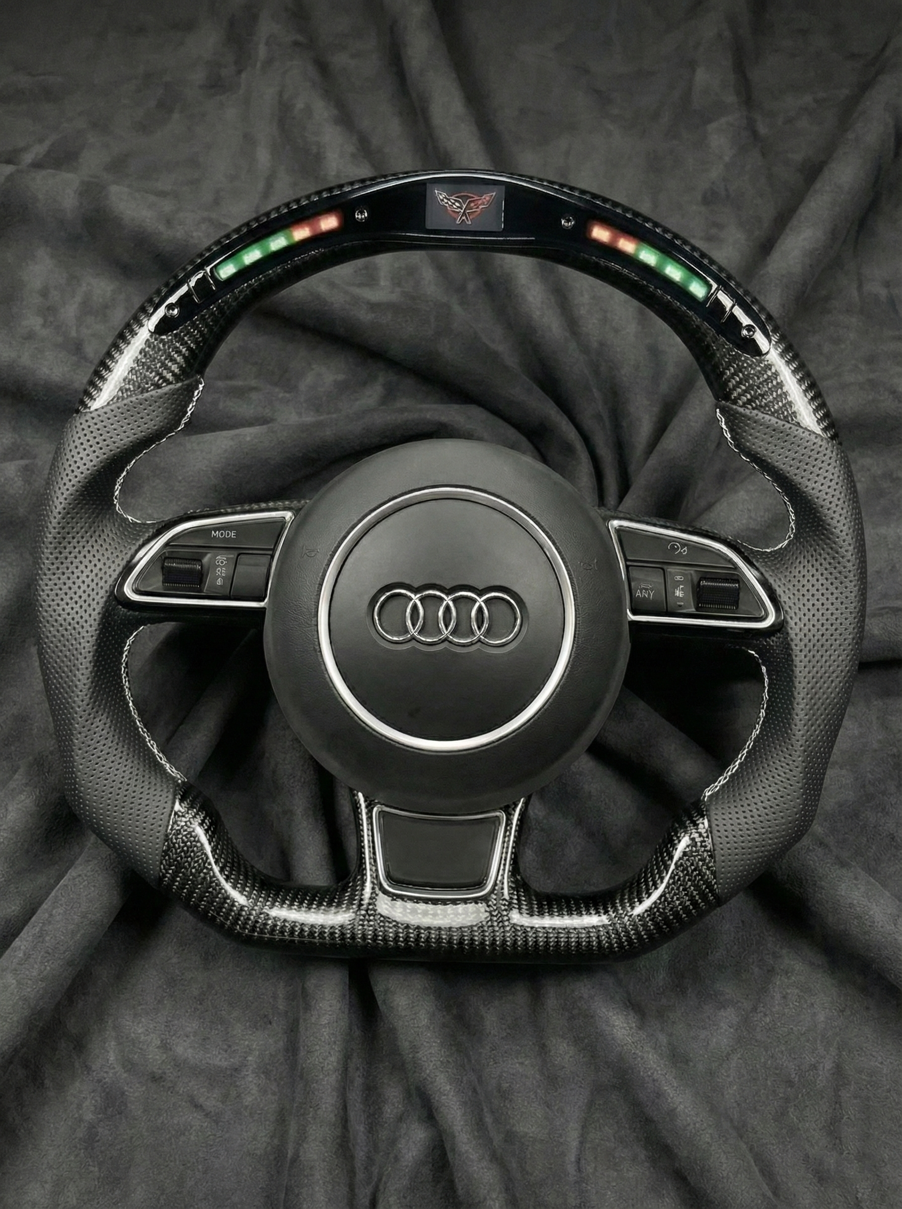 Steering wheel with Audi logo on a dark background