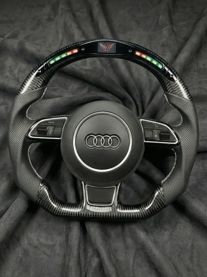 Steering wheel with Audi logo on a dark background