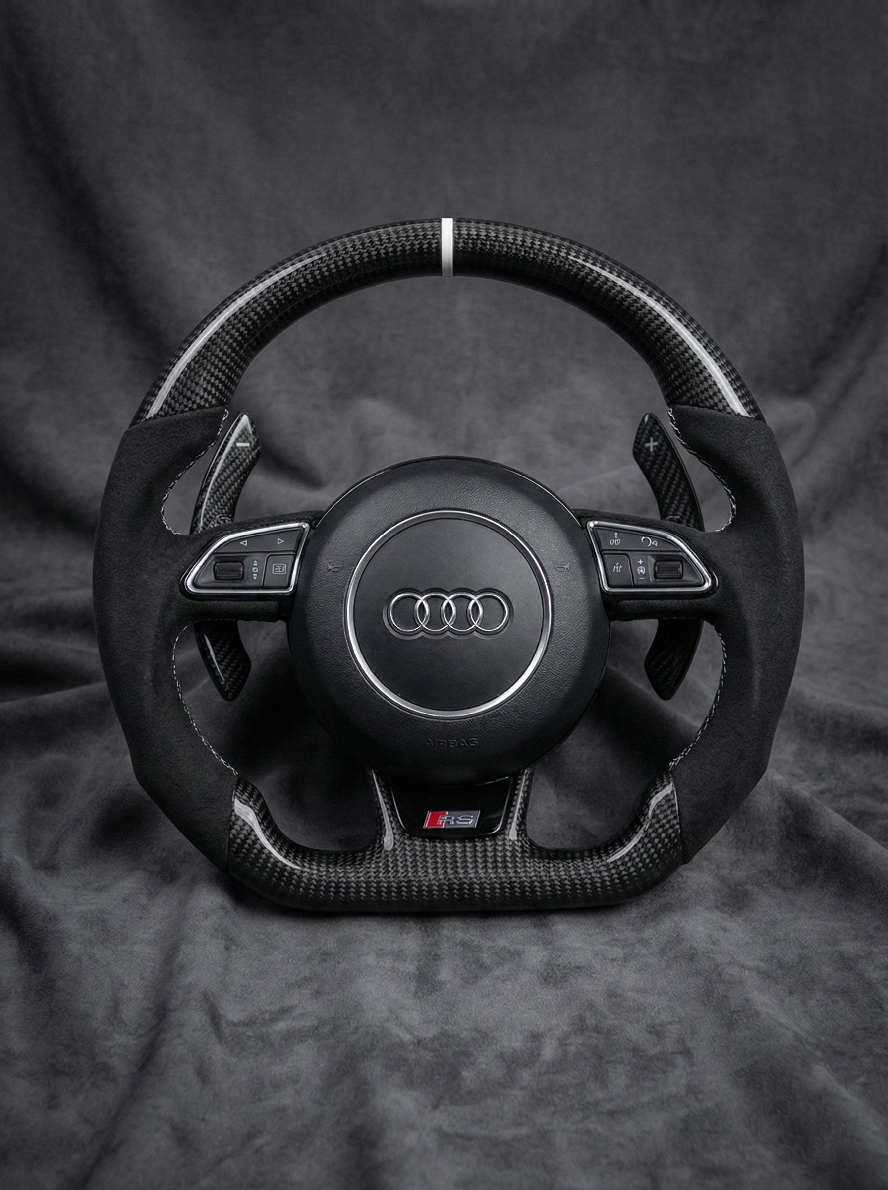 Steering wheel with Audi logo on a dark background