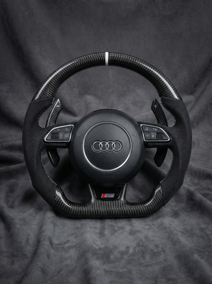 Steering wheel with Audi logo on a dark background