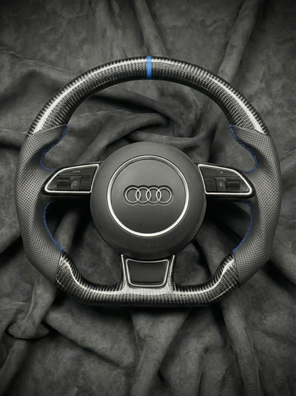 Steering wheel with Audi logo on a dark fabric background