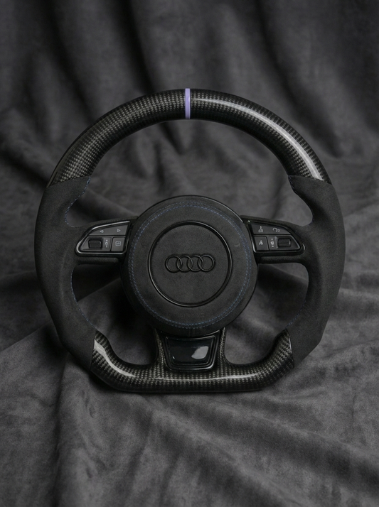 Steering wheel with Audi logo on a textured gray background