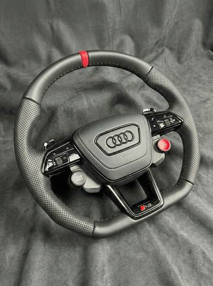 Steering wheel with Audi logo on a gray background