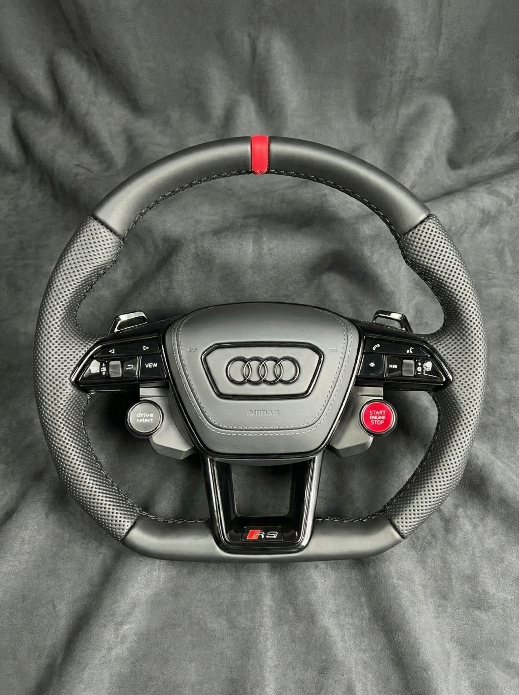 Audi steering wheel on a gray background