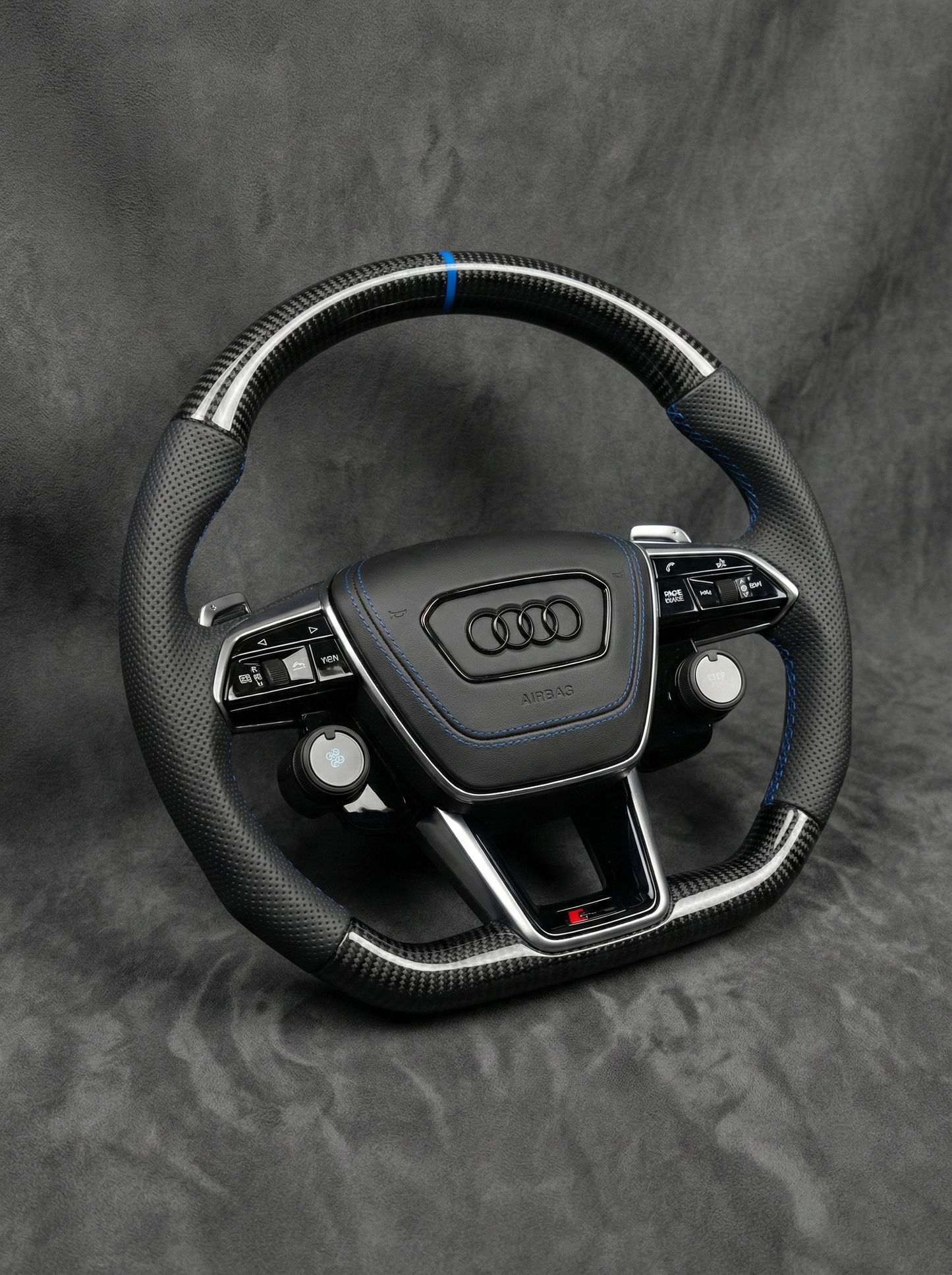 Audi steering wheel on a gray background