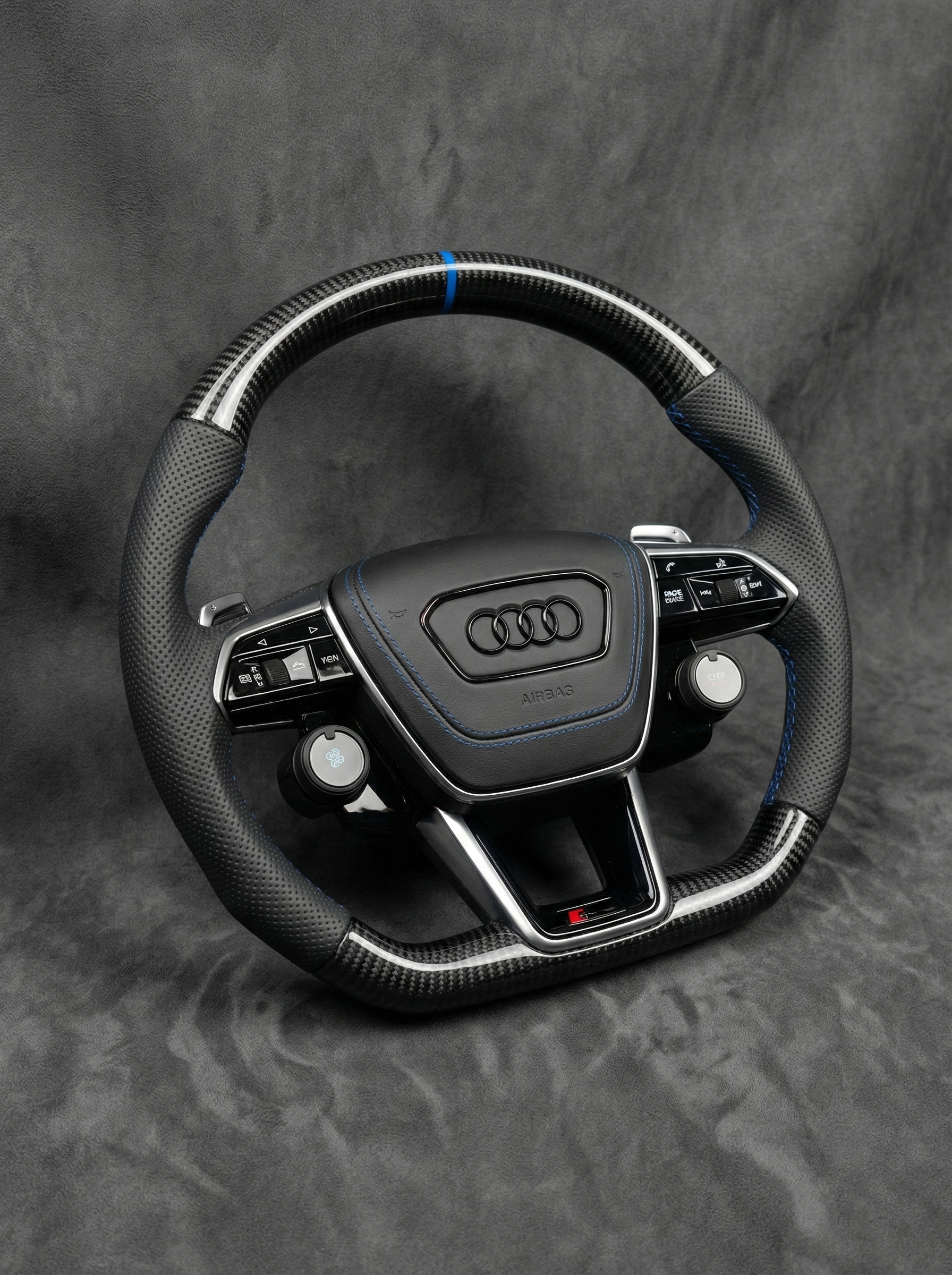 Audi steering wheel on a gray background