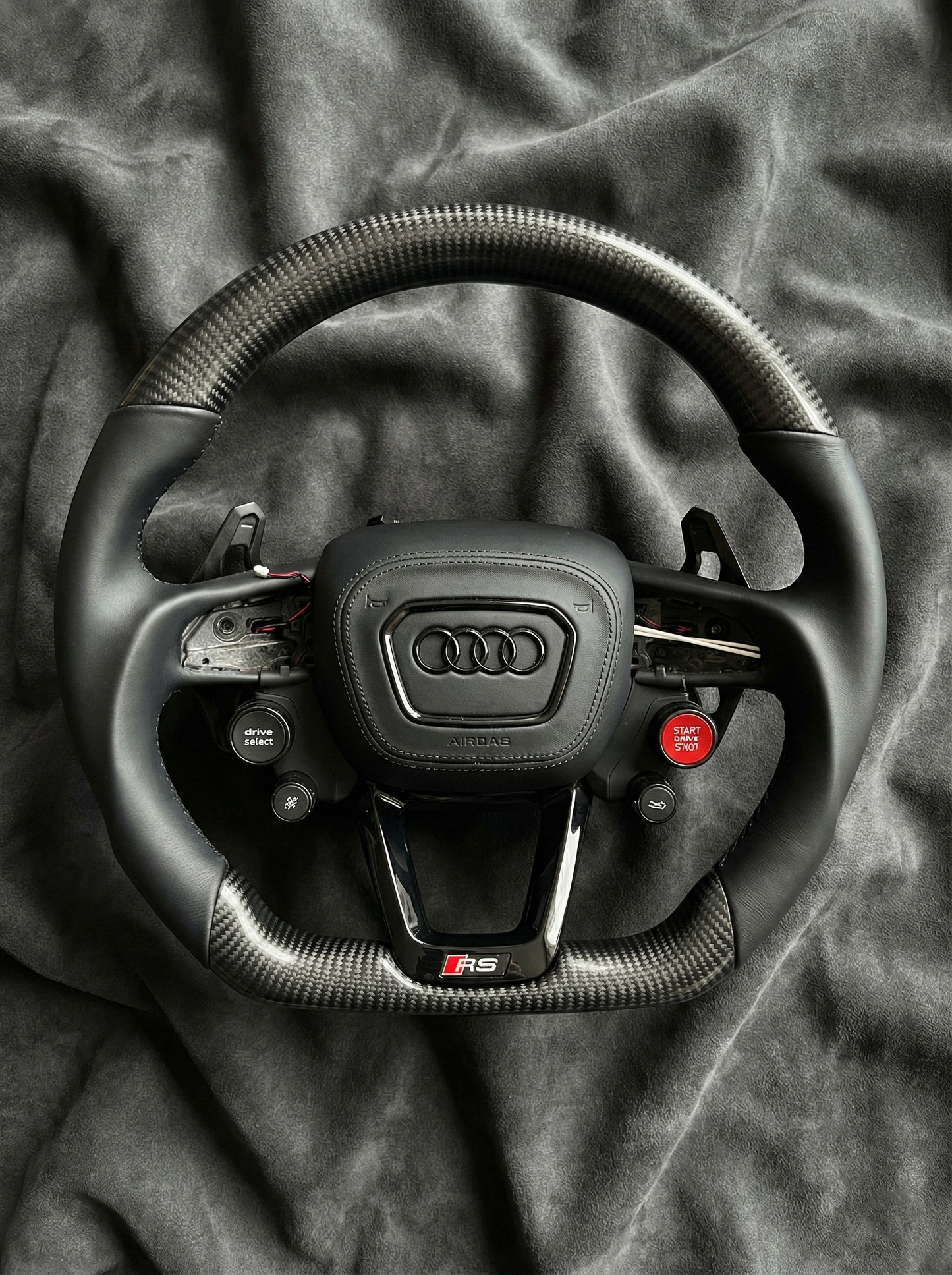 Audi steering wheel on a dark fabric background