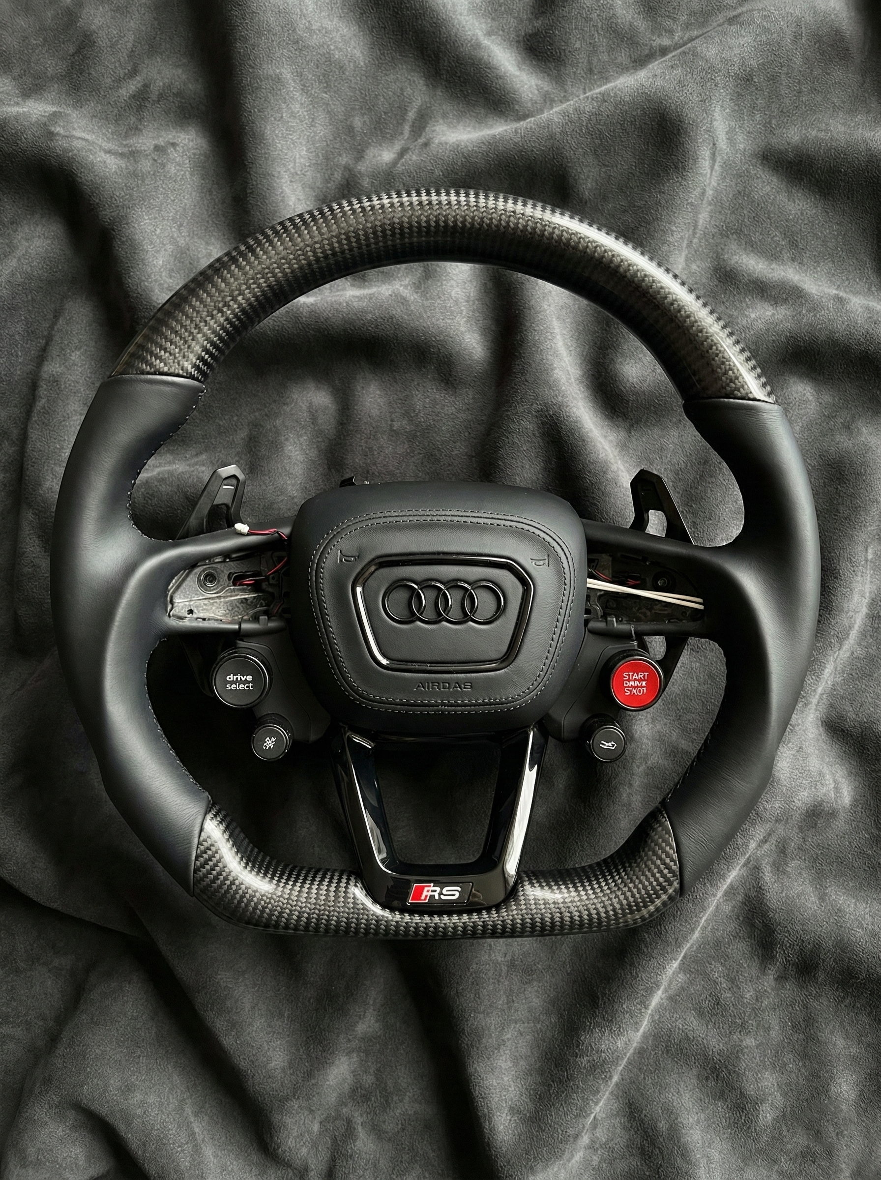 Audi steering wheel on a dark fabric background