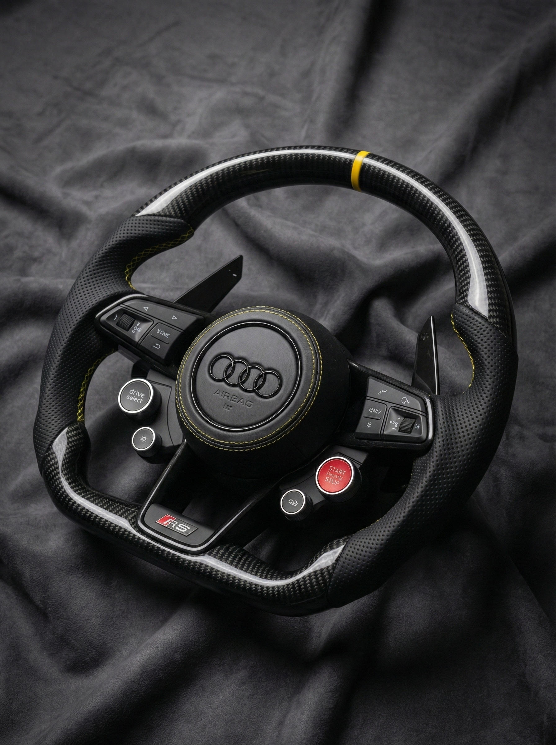 Audi steering wheel on a dark fabric background