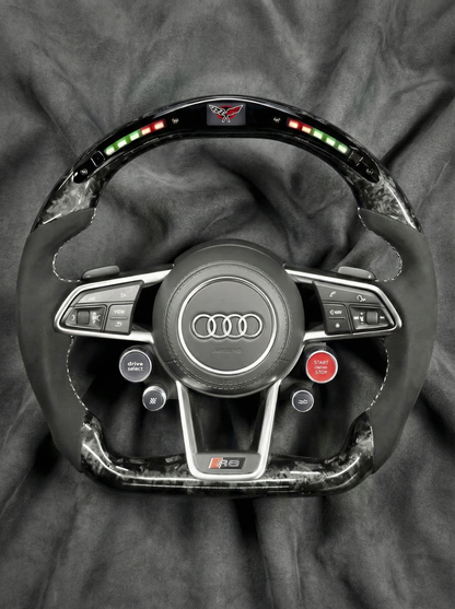 Steering wheel with Audi logo on a gray background