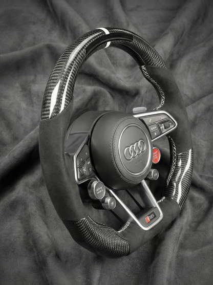 Audi steering wheel on a dark fabric background