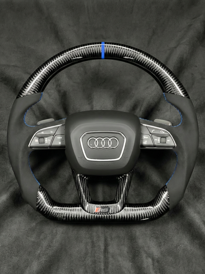 Steering wheel with Audi logo on a dark background