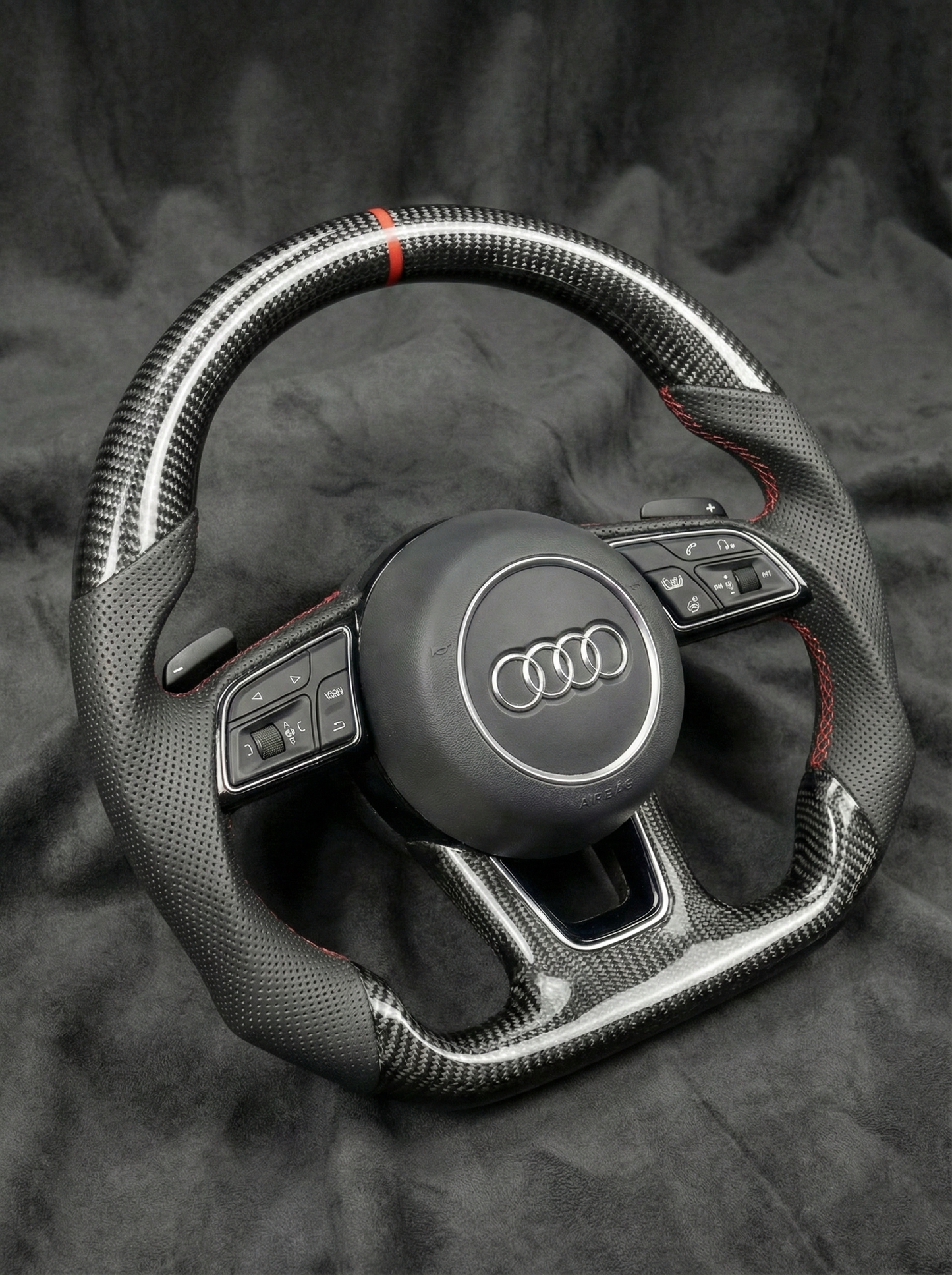 Steering wheel with Audi logo on a dark background