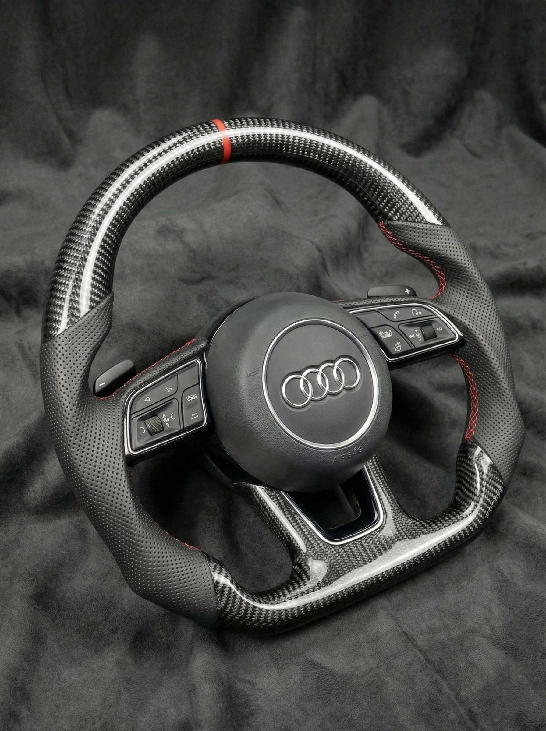 Steering wheel with Audi logo on a dark background