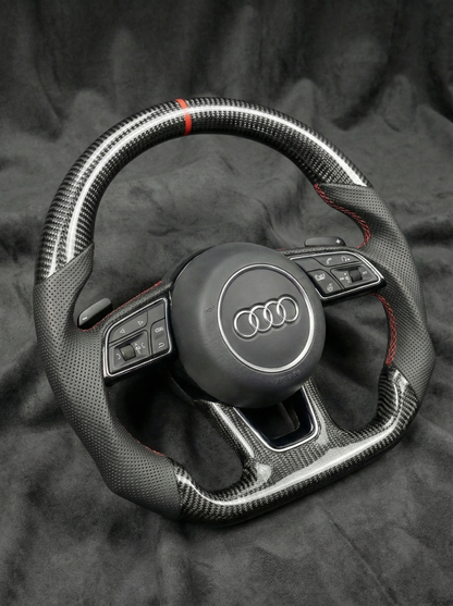 Steering wheel with Audi logo on a dark background