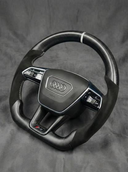 Steering wheel with Audi logo on a gray background