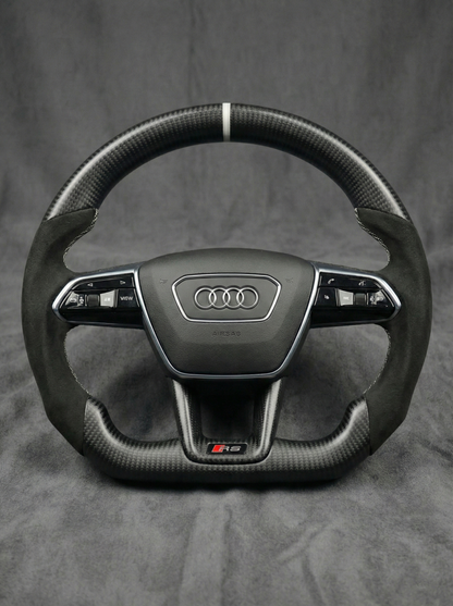 Carbon fiber steering wheel with Audi logo on a gray background