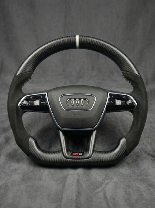 Carbon fiber steering wheel with Audi logo on a gray background